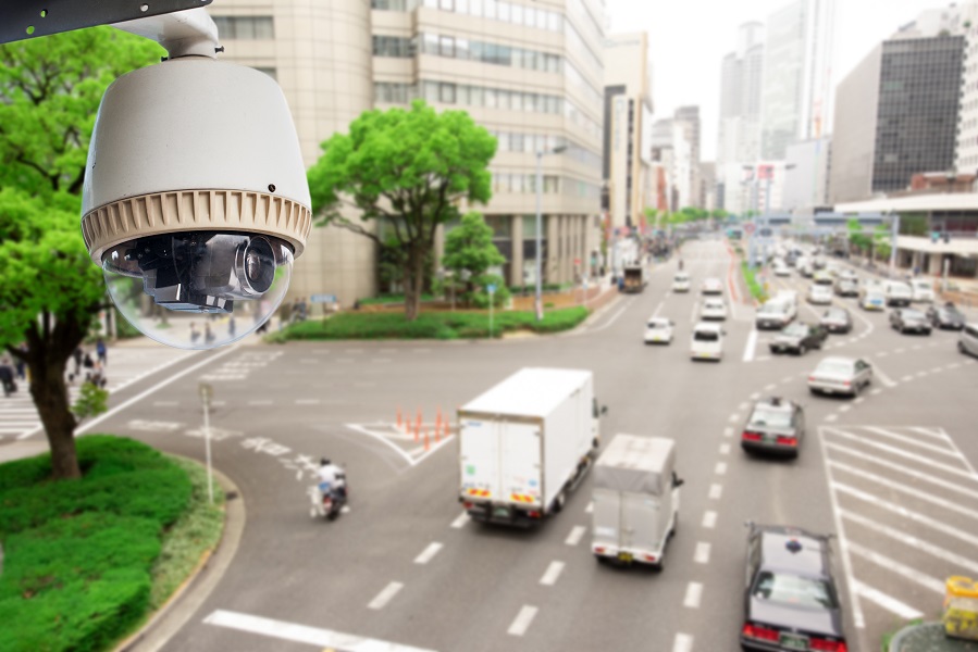 CCTV Surveillance camera operating on traffic road and people cross road in japan